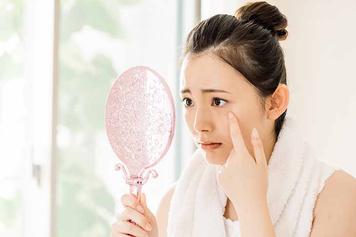 目元を鏡で見る女性